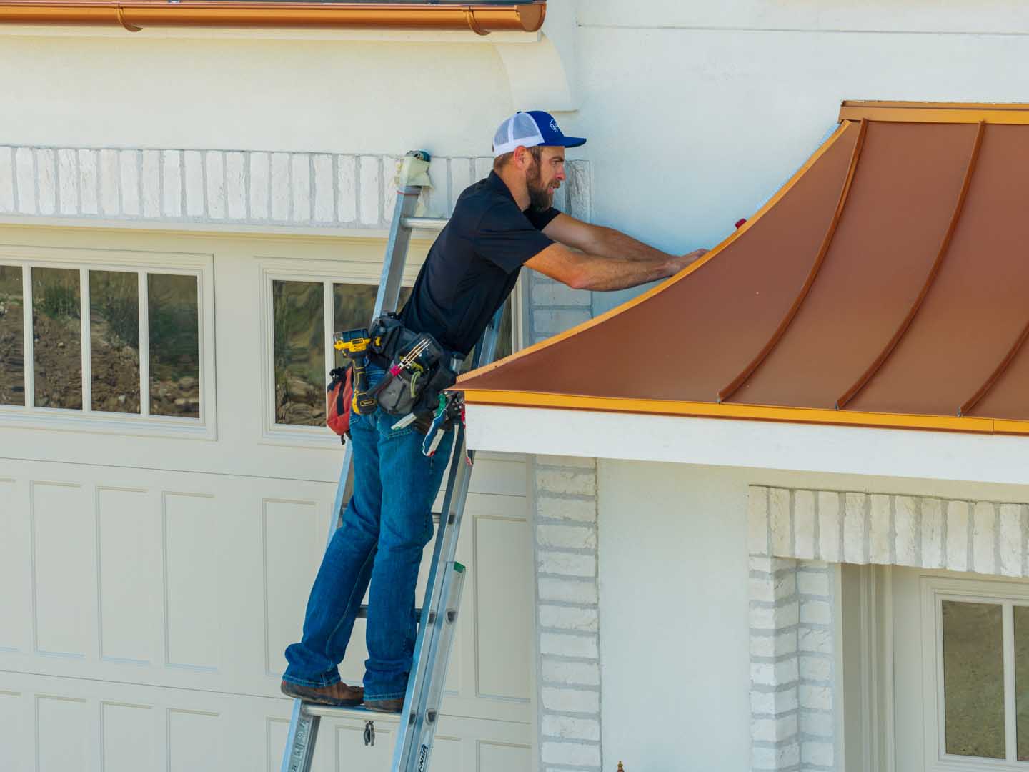 an Osmus Roofing employee working on the finishing touches on a roof in Eagle, Idaho.
