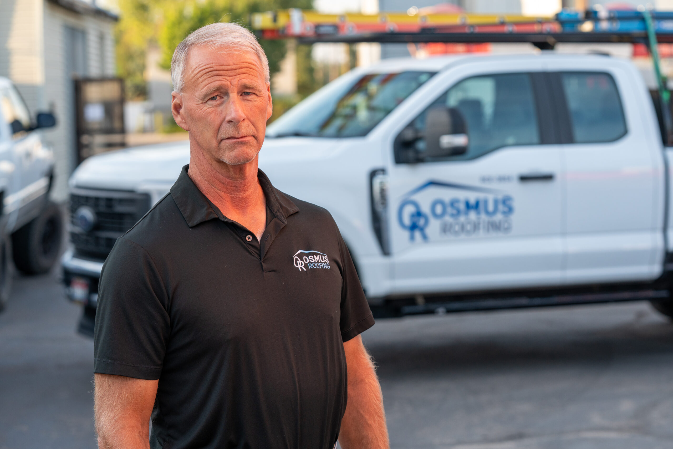 Osmus Roofing owner with company truck